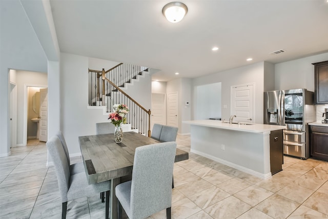 tiled dining room featuring sink