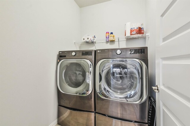 washroom with washing machine and clothes dryer