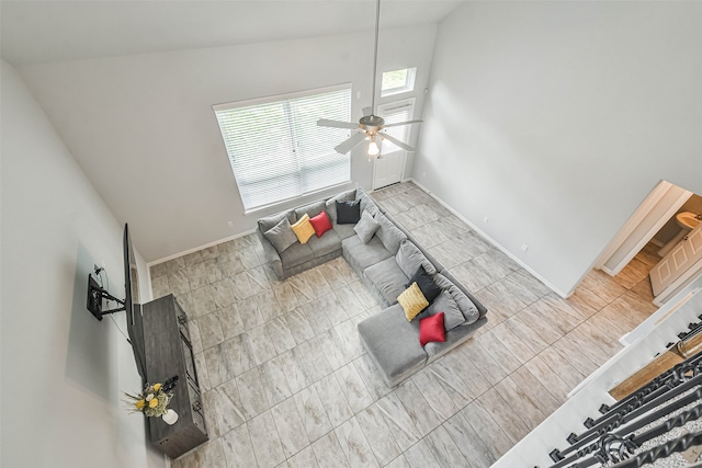 unfurnished living room featuring high vaulted ceiling, light tile patterned floors, and ceiling fan