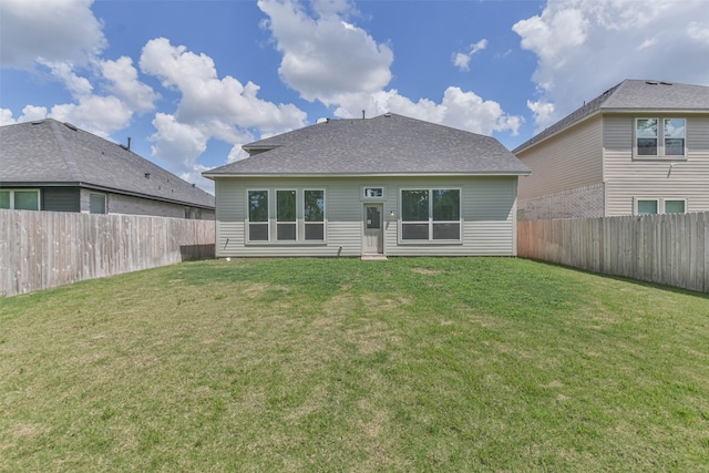 back of house featuring a lawn