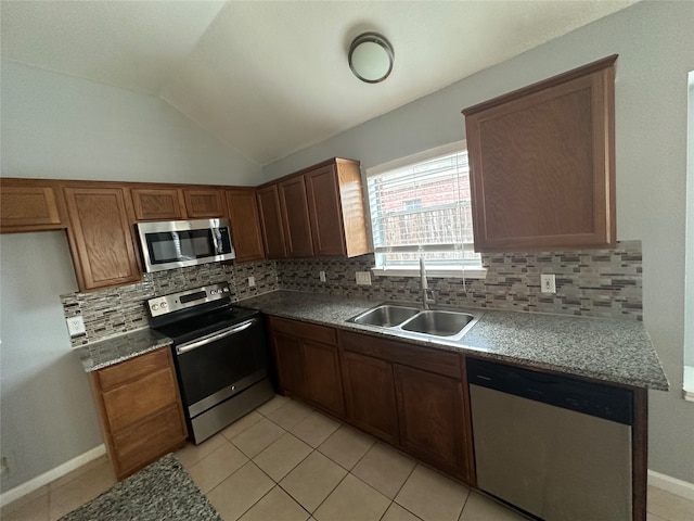 kitchen featuring light tile patterned floors, stainless steel appliances, tasteful backsplash, and sink