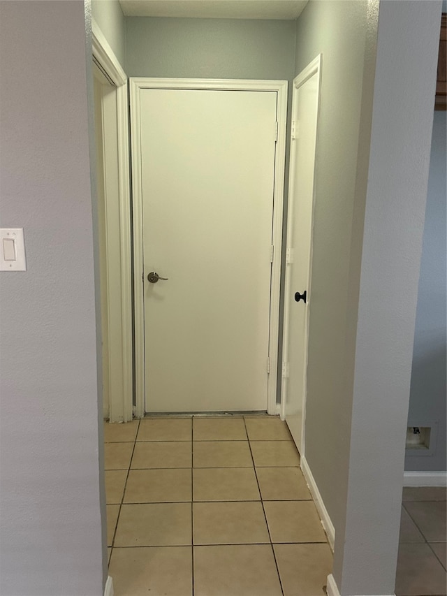 corridor featuring light tile patterned floors