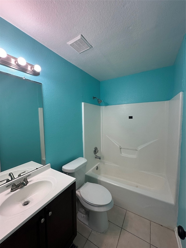 full bathroom featuring tile patterned flooring, shower / bathing tub combination, a textured ceiling, toilet, and vanity