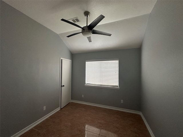 spare room with tile patterned flooring, ceiling fan, and lofted ceiling