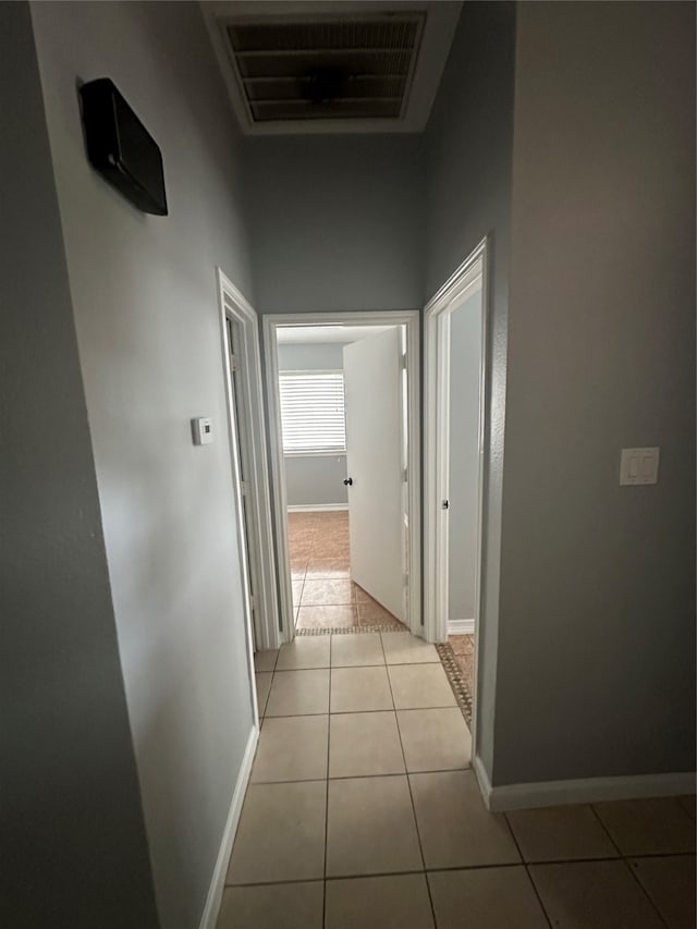 corridor featuring light tile patterned floors