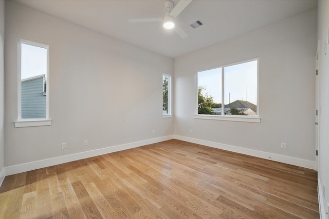 empty room with light wood-type flooring and ceiling fan