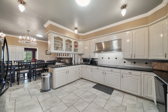 kitchen with white cabinets, dishwasher, backsplash, an inviting chandelier, and wall chimney range hood