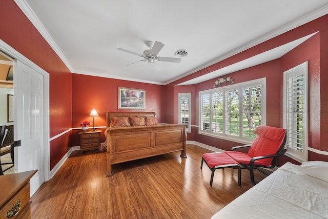 bedroom featuring crown molding, dark hardwood / wood-style flooring, and ceiling fan