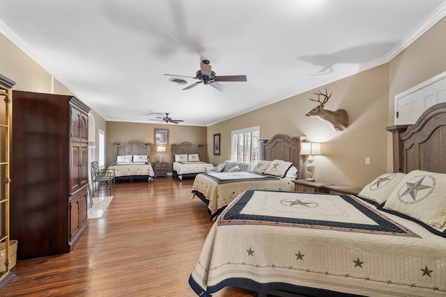 bedroom with ceiling fan, hardwood / wood-style flooring, and ornamental molding