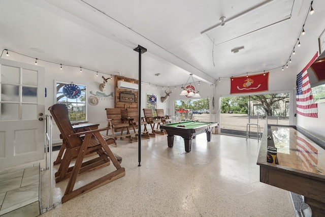 game room with beamed ceiling, pool table, a wall mounted air conditioner, and a wealth of natural light