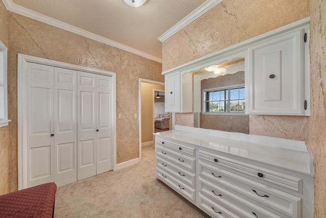 carpeted bedroom with ornamental molding and a closet