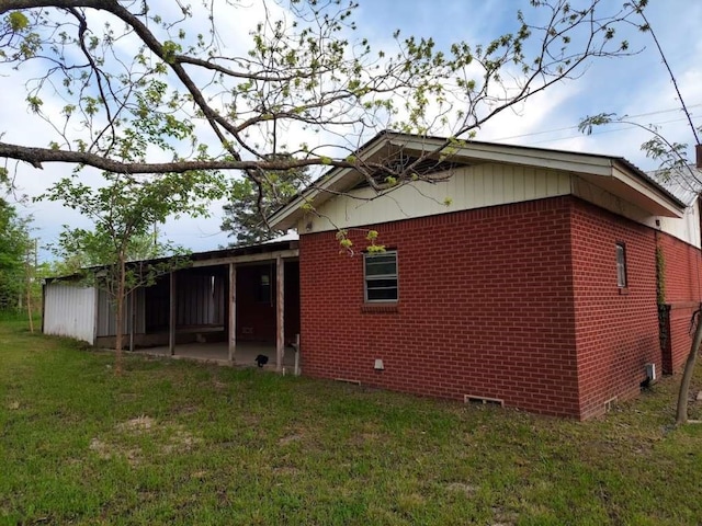 rear view of property featuring a yard