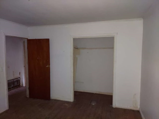 unfurnished bedroom featuring wood-type flooring and a closet