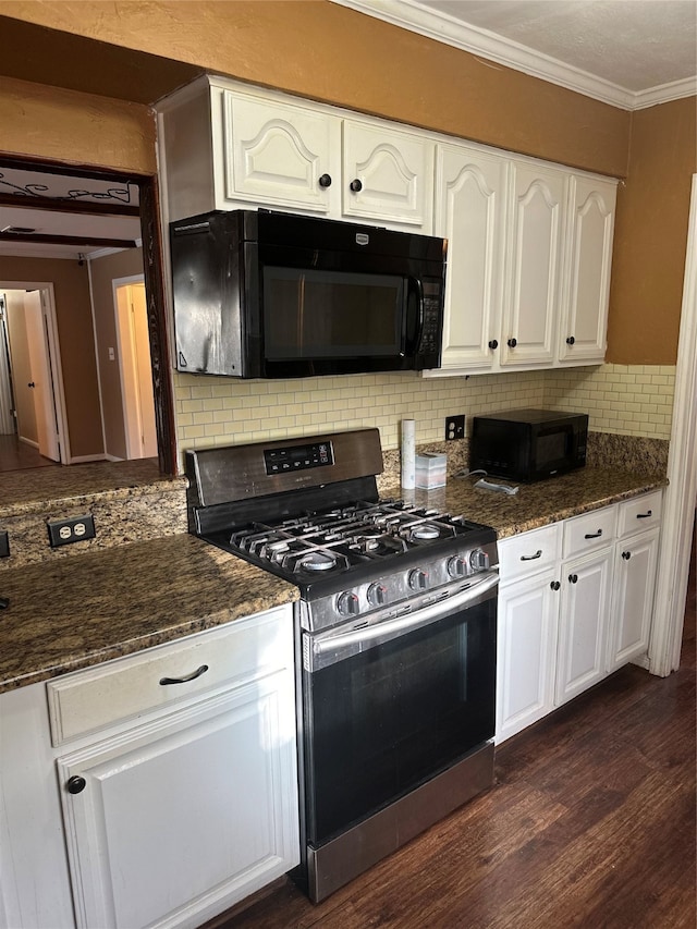 kitchen featuring decorative backsplash, dark stone countertops, white cabinetry, dark hardwood / wood-style flooring, and stainless steel range with gas stovetop