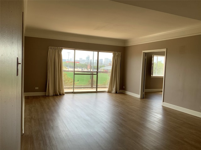 unfurnished room with dark hardwood / wood-style flooring and ornamental molding