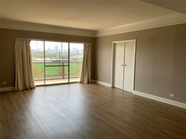 spare room featuring hardwood / wood-style flooring and crown molding