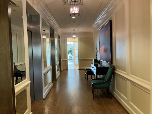 corridor featuring an inviting chandelier, dark wood-type flooring, and crown molding