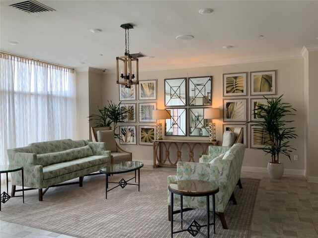 living area with tile patterned floors and crown molding