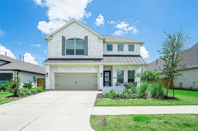 view of front of house with a garage and a front lawn