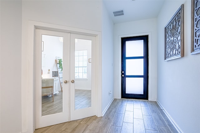 doorway to outside with french doors and hardwood / wood-style floors