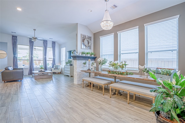 interior space featuring light hardwood / wood-style flooring, a wealth of natural light, and vaulted ceiling