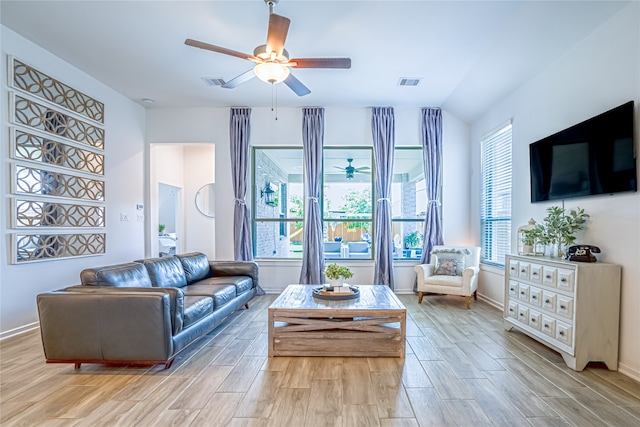 living room with light wood-type flooring, ceiling fan, and lofted ceiling