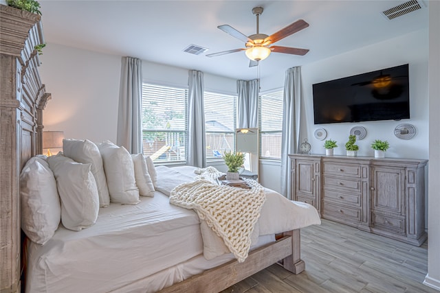 bedroom with light hardwood / wood-style floors and ceiling fan