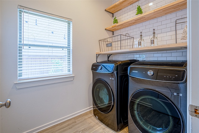 laundry area with light wood-type flooring and independent washer and dryer