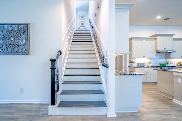 staircase with light wood-type flooring