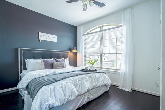 bedroom with multiple windows, ceiling fan, and hardwood / wood-style floors