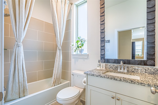 full bathroom with shower / bath combo with shower curtain, toilet, a wealth of natural light, and vanity