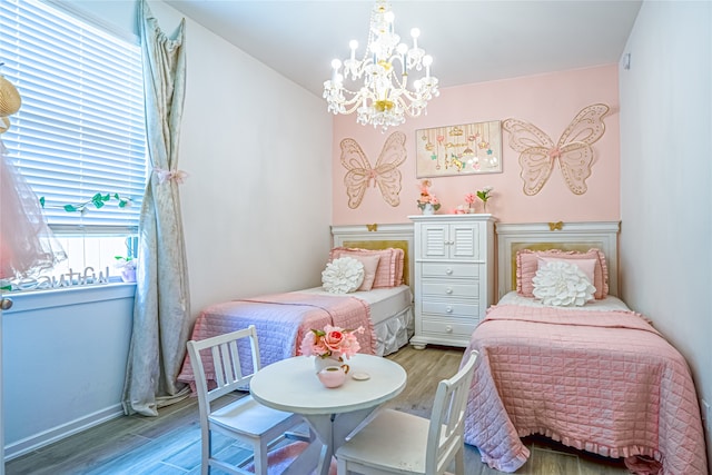 bedroom with hardwood / wood-style flooring and a notable chandelier