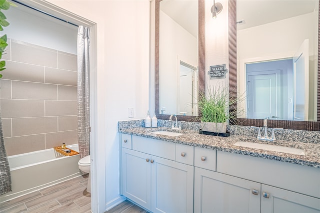 full bathroom with shower / bath combo, toilet, and dual bowl vanity