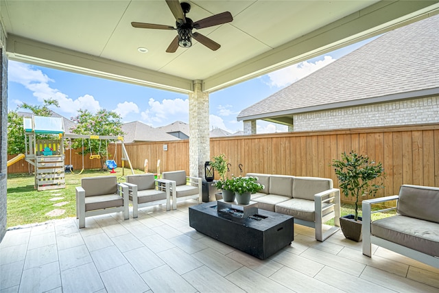 view of patio featuring a playground, outdoor lounge area, and ceiling fan