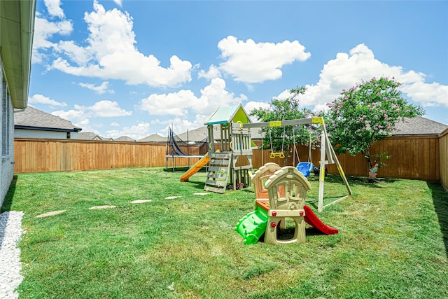 view of playground with a lawn