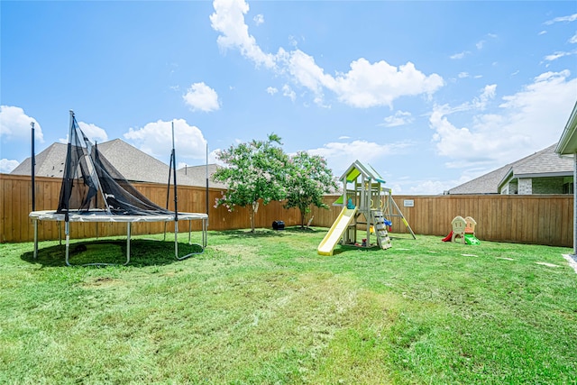 view of yard with a playground and a trampoline