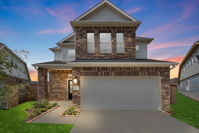 view of front of house featuring a garage and a yard