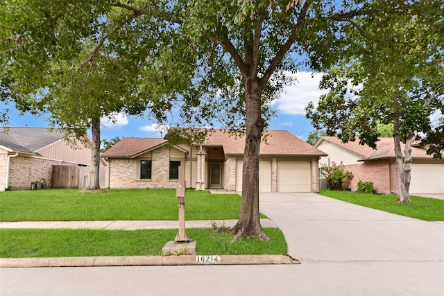 single story home with a garage and a front lawn