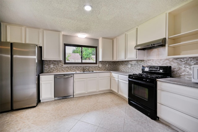 kitchen with stainless steel appliances, white cabinetry, sink, and decorative backsplash