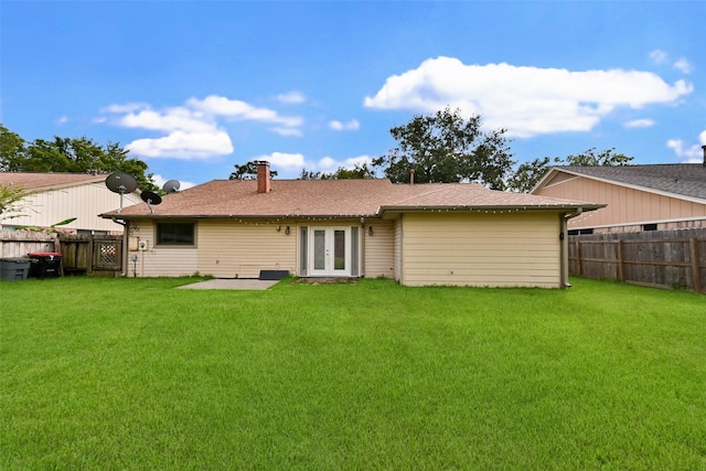 back of house featuring a yard, a patio area, and french doors