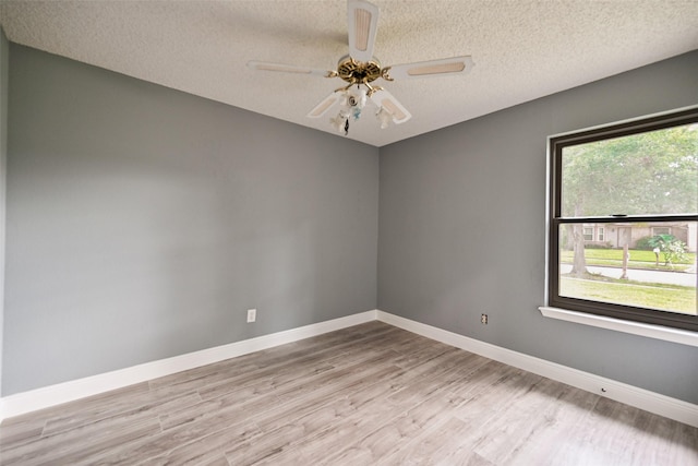 spare room with ceiling fan, a textured ceiling, and light hardwood / wood-style floors