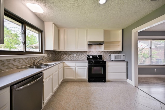 kitchen with black gas range oven, white cabinetry, ventilation hood, and stainless steel dishwasher