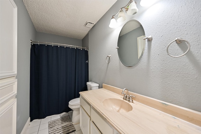 bathroom featuring tile patterned flooring, vanity, toilet, and a textured ceiling