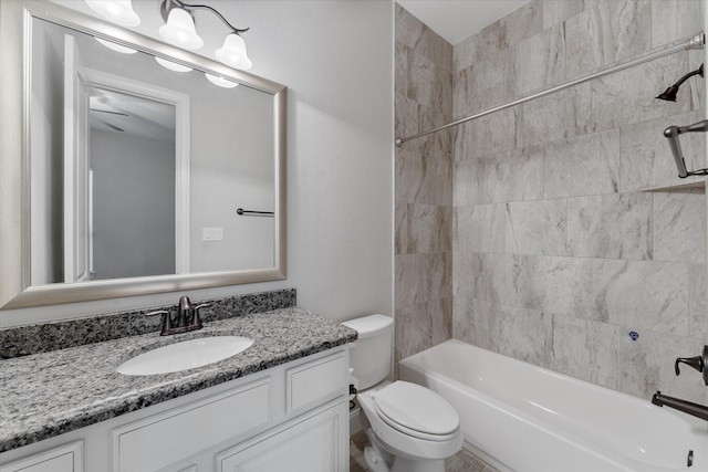 full bathroom featuring tiled shower / bath combo, vanity, and toilet