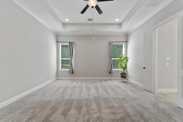 spare room featuring a tray ceiling, ornamental molding, and ceiling fan