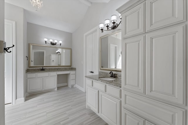 bathroom featuring an inviting chandelier, vaulted ceiling with beams, hardwood / wood-style floors, and vanity