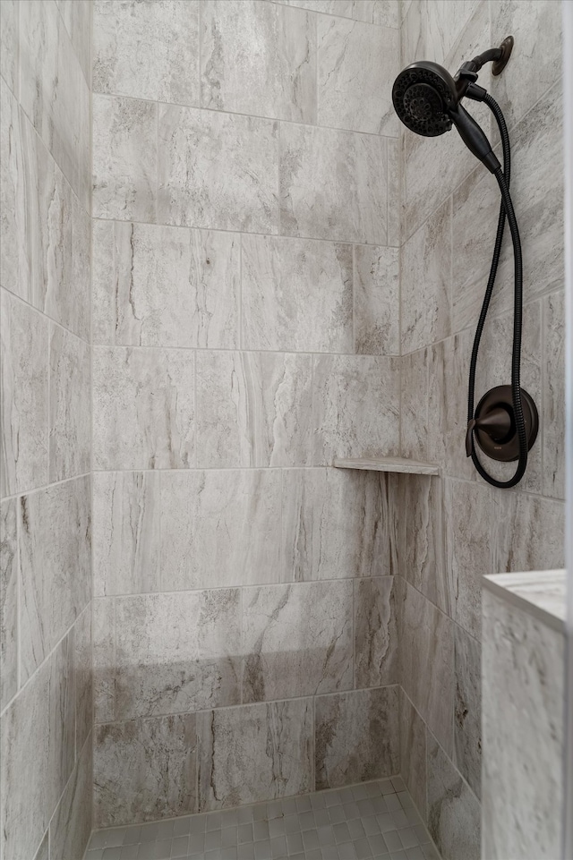 bathroom with tiled shower