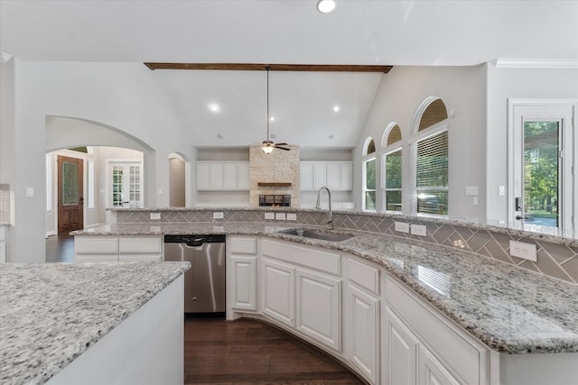 kitchen featuring ceiling fan, vaulted ceiling with beams, hanging light fixtures, sink, and dishwasher