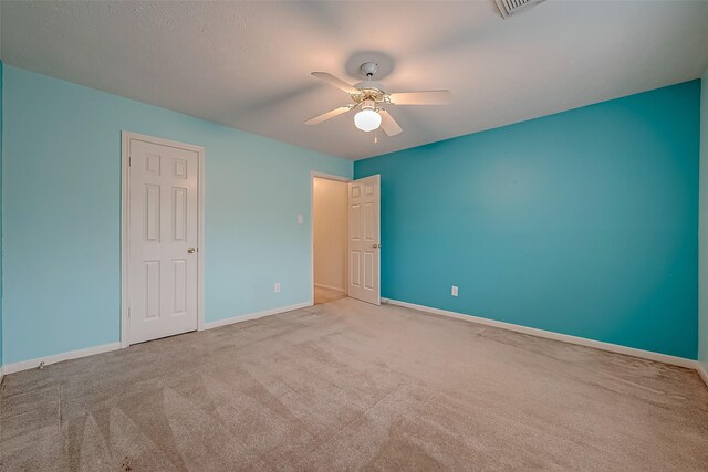 interior space featuring light carpet and ceiling fan