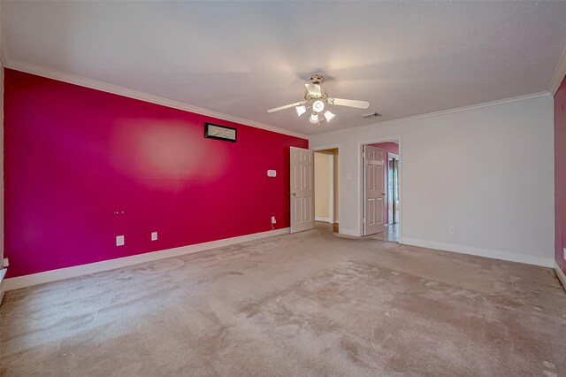 spare room with carpet, crown molding, and ceiling fan